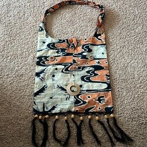 Tribal cloth handbag with wooden beads and black tassels